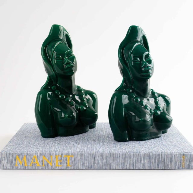 Elegant pair of ceramic bust sculptures portraying mythical goddesses glazed in a rich, deep emerald green finish. These...
