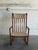 This striking rocking armchair features a tall spindle back and sweeping curved armrests. The elegant silhouette showcases...