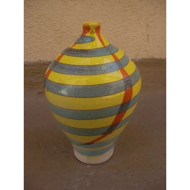 The shape of this vintage, ceramic vase is accentuated by a wonderful design swirling around the body in blue/brown stripe...