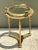 This vintage brass and glass porthole accent table brings authentic mid-century maritime design to any interior, its round...