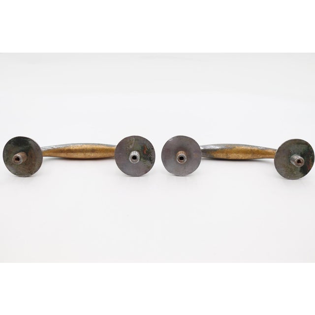 Vintage nickel plated brass door pulls with a curved shaped handle and circular plates. The original mounting screws are...