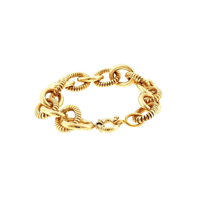 A late 20th-century 14k gold link bracelet. Crafted in Italy. Features interlocking circular links with alternating bright...