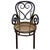 The Victorian Thonet number 04 armchair features an elegant, sculptural frame crafted from warm-toned bentwood with...