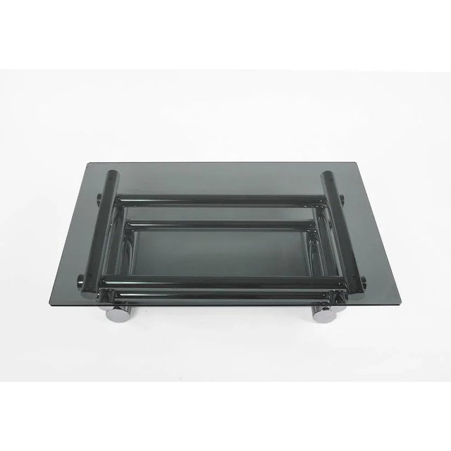 Mid-Century Modern smoked glass coffee table in chrome-plated tubular in the style of Paul Mayen. A great example of 1970s...