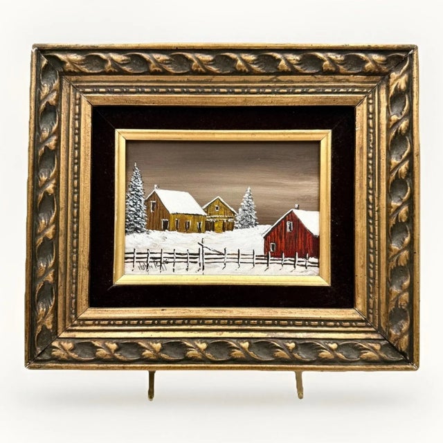 Charming pair of vintage winter landscape oil paintings depicting quiet snowy countryside scenes with rbarns. Both works...