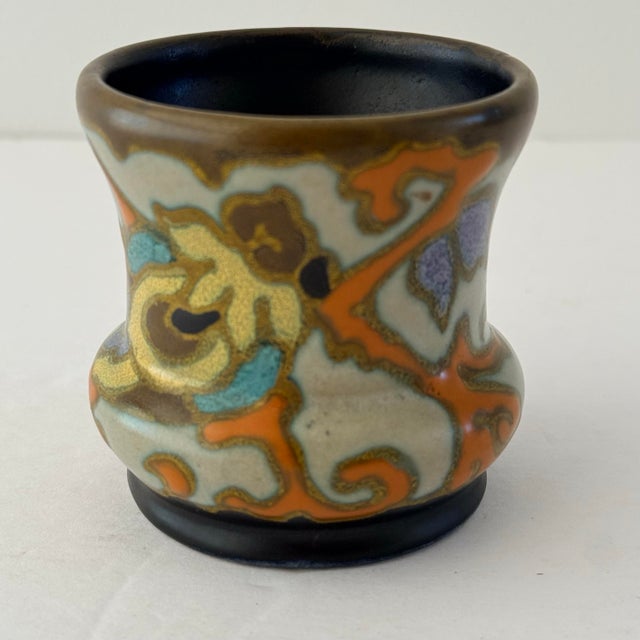 A charming miniature example of early 20th-century Dutch Gouda pottery, this antique vase was produced by Plateelbakkerij...