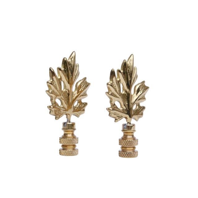 A pair of brass maple leaf lamp finials. Fits a standard size lamp harp. Dimensions per finial. We have more lamp finials...