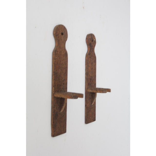 These antique wooden brackets were originally part of a simple yarn swift, giving them a subtle textile history that...
