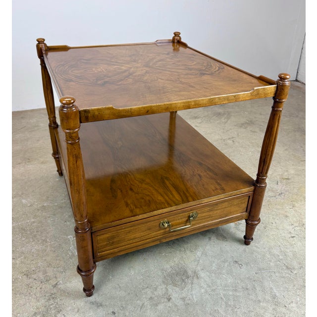 A fabulous vintage Baker Furniture French Regency Louis XVI Style burled walnut two-tier side table of nightstand circa...