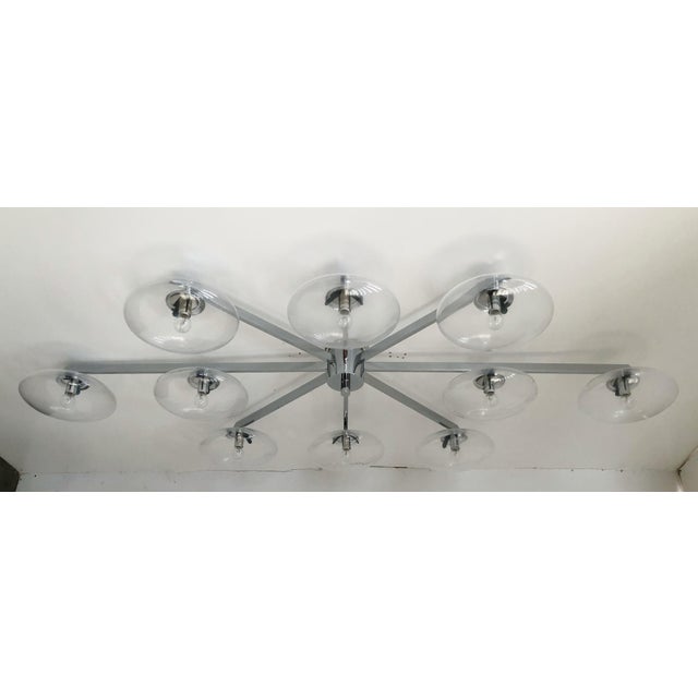 Italian midcentury flush mount with ten clear Murano glass shades mounted on solid brass frame in polished chrome finish /...