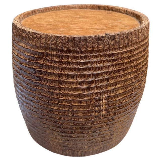 Originally used to carry water, this antique container has been hand carved by our master carver showing an impressive...