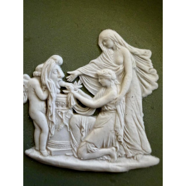 This set of two vintage Wedgwood Jasperware plates features the classic sage green ground with crisp white relief...