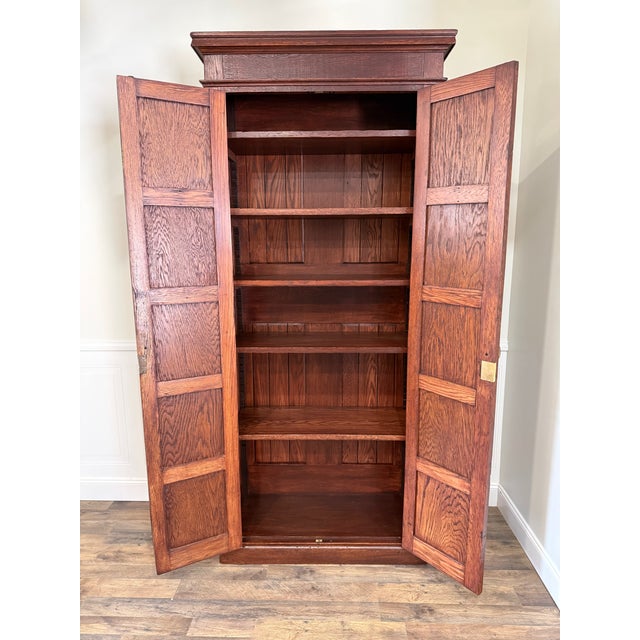 Lovingly restored by Hilaire Furniture Co., this substantial early 20th century solid oak cabinet has been carefully...