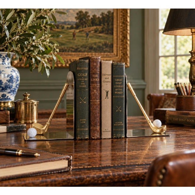 A wonderfully playful pair of circa-1980s bookends combining polished metal bases with sculptural cast brass golf clubs...
