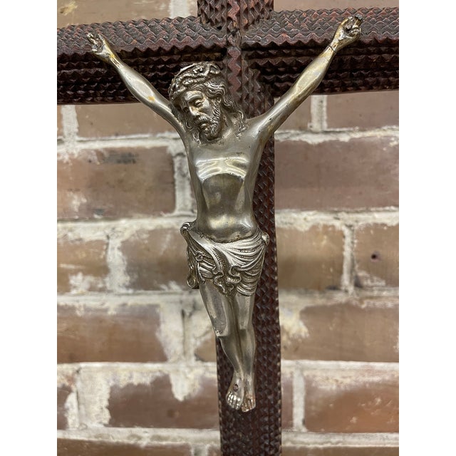 This antique Tramp Art crucifix is a free standing cross accented with a metallic Corpus Christi. The piece represents a...