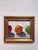 This oil painting features three vibrant fruitsan orange, a red apple, and a green appleset against a softly textured...