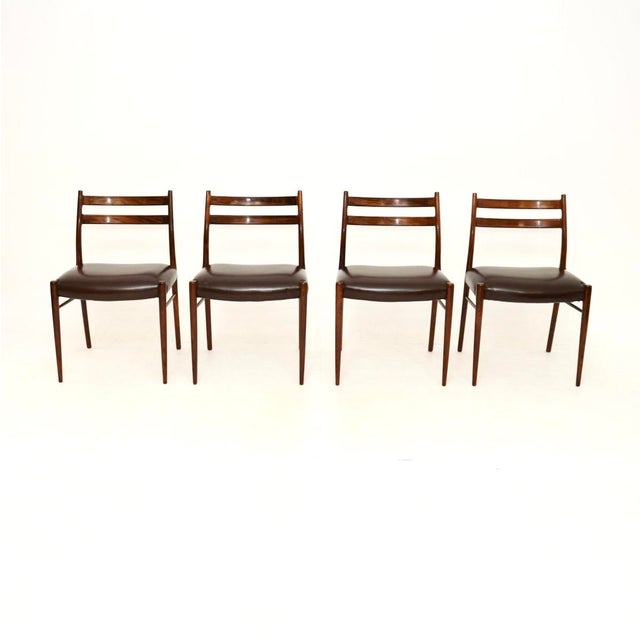 A stylish, rare and extremely well made set of four Danish and leather dining chairs by Arne Wahl Iversen. They are the...