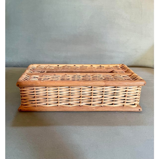 A vintage wicker-work tissue box cover trimmed with round wood pieces at the edges and in the center made for rectangular...