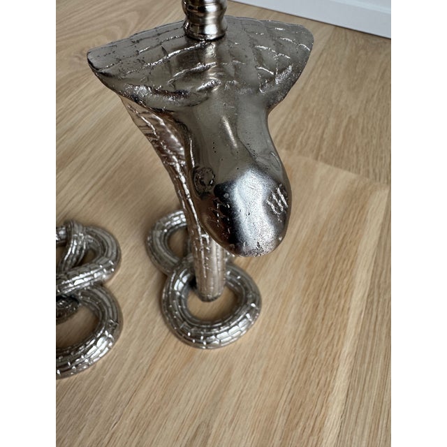 An exceptional pair of 1930s Egyptian bronze candlesticks, newly nickel plated to create a luminous, architectural finish...