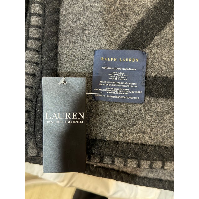 Add a touch of understated luxury to your living space with this sophisticated charcoal gray and black throw blanket....
