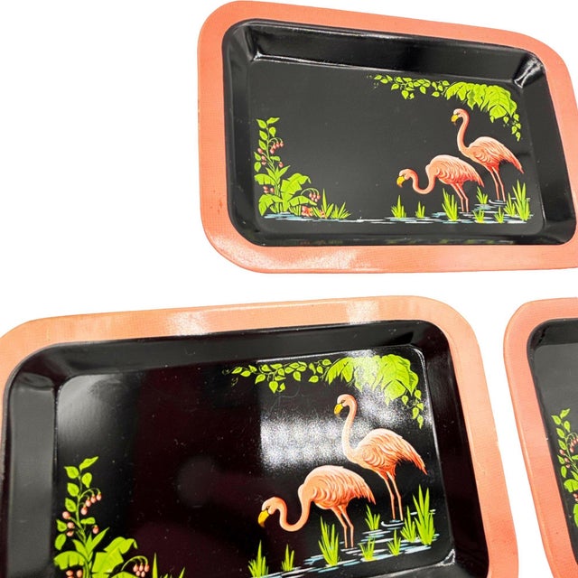 Set of 3 Mid-century pink and green ceramic flamingo theme decorative tin serving TV trays. The tray features a modern...