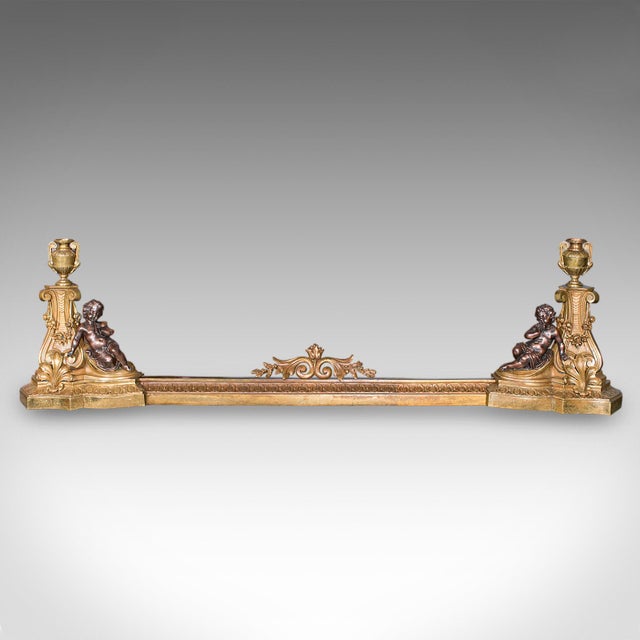 This is an antique adjustable fireplace fender. An English, brass extending fire kerb, dating to the late Victorian...