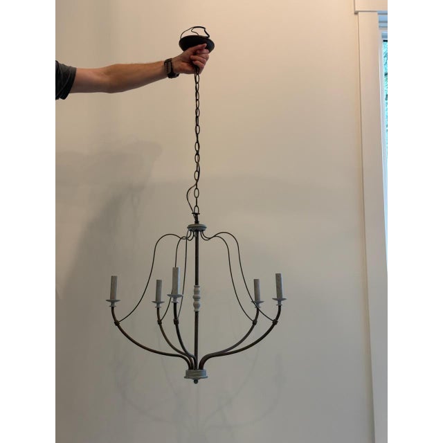 We love how this 5-light chandelier pairs distressed white wood accents and a weathered iron body for a rustic look. Its...