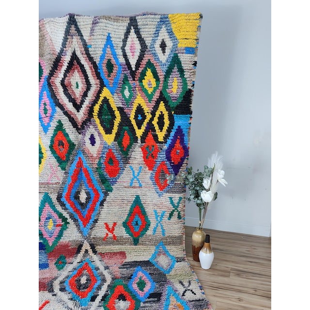 A large, vibrant Boujaad rug hand-knotted by Berber artisans in the Boujaad region of Morocco. The field is a lively...