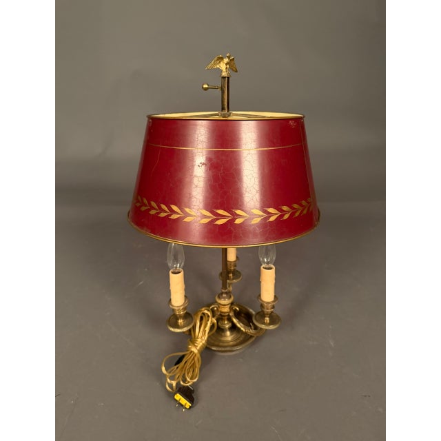 Elegant French table lamp dating to circa 1900, featuring a bronze and iron three-arm electrified form in the Bouillotte...
