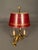 Elegant French table lamp dating to circa 1900, featuring a bronze and iron three-arm electrified form in the Bouillotte...