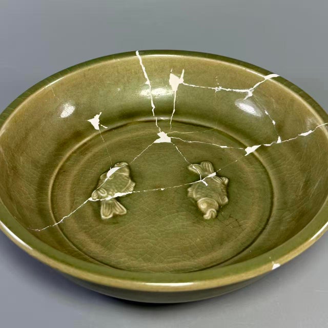 Antique Chinese Longquan celadon plate with molded twin fish decoration at center. Rich aged celadon glaze, classic...