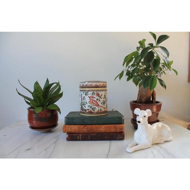 Vintage hand painted Portuguese ceramic canister or trinket pot with bird, animal, houses and flowering motif. Makers mark...