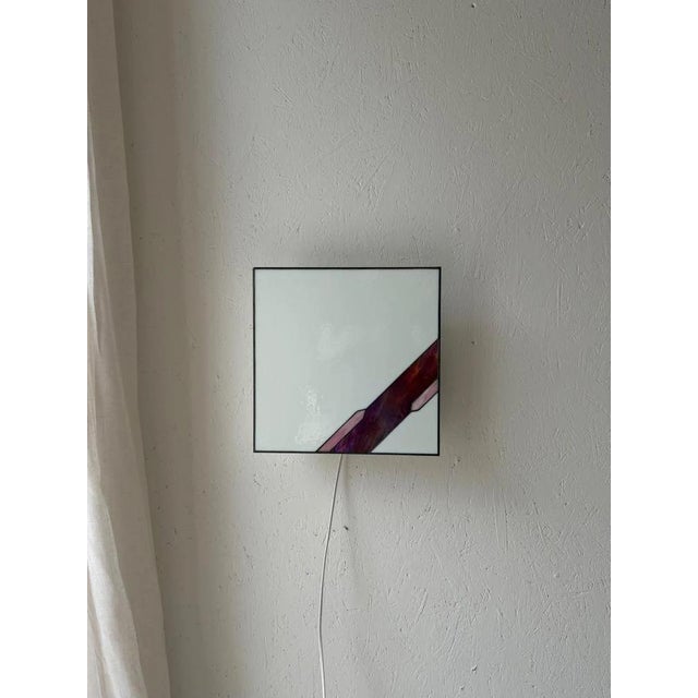 This vintage wall lamp demonstrates how powerful a simple design can be. The large panel of white textured glass forms a...