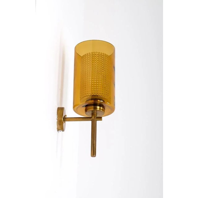Set of 3 brass and glass wall lights, produced in Sweden, 1950s. Up to 250V (Europe/UK Standard).The wiring of this item...