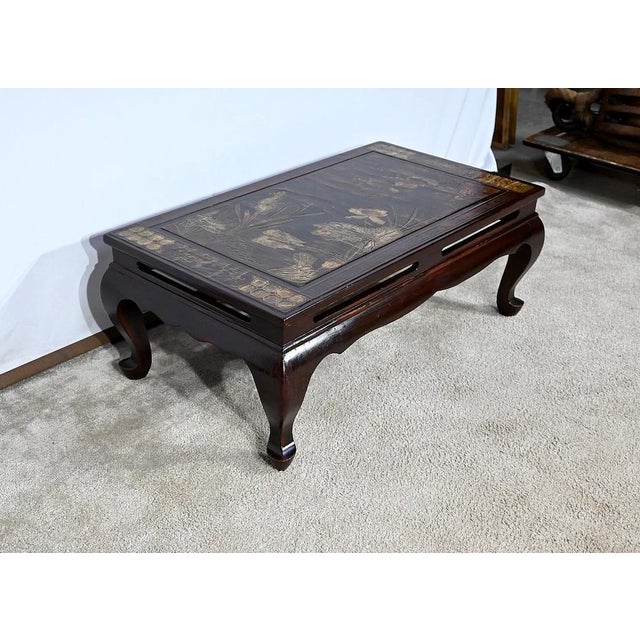 Chinese rectangular coffee table, fully lacquered, dark brown in color. Its original top is made up of inlaid patterns...