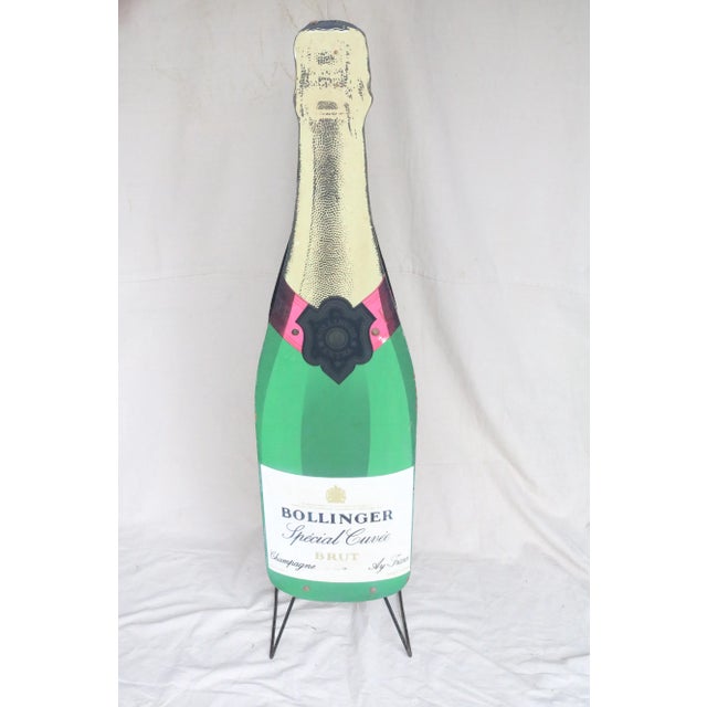 A very unusual wine rack intended as a store display for Bollinger champagne. The two ends of the rack are in the shape of...