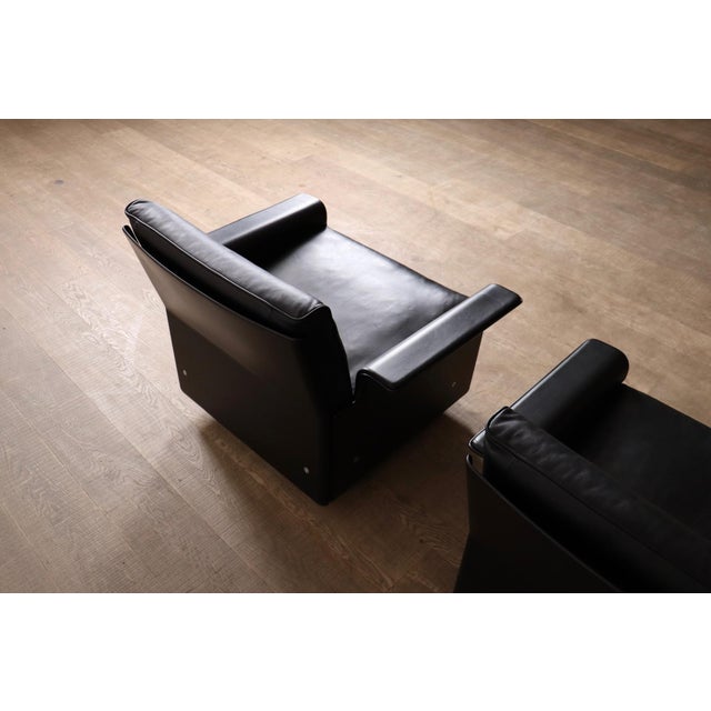 Iconic pair of model 620 lounge chairs in black leather with black outer shell by dieter rams for vitsoe, germany 1980s....