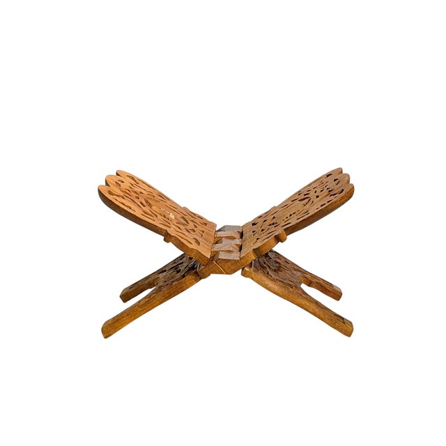 Vintage hand carved from one piece of wood fold g book stand. Carved foliage design. Folds neatly. Original makers label.