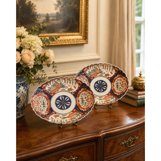 An antique Japanese Meiji pair of unusual Imari porcelain dishes with scalloped oval forms and richly hand-painted...