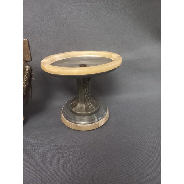 Pendulum and a pair of Art Deco Cassoletes in Turquin blue marble and yellow onyx. Travel to Venice. A couple in Venetian...