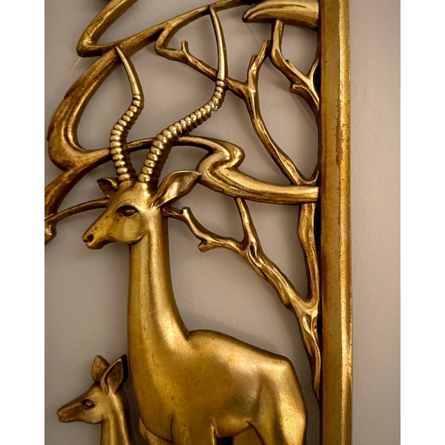 A sculptural mid-century decorative panel featuring a stag and fawn framed within stylized woodland forms. Lightweight and...