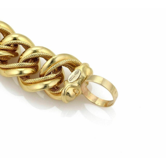 The product is a vintage 18k yellow gold link bracelet measuring 8 inches in length. It features a stylish and unique...