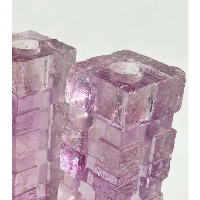 Set of three sculptural 1970s candle holders crafted from violet purple lucite in a frosted and clear block pattern. The...