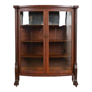R. J. Horner Style Antique American Empire Oak Bow Front Bookcase Cabinet With Lion's Paw Feet, Circa 1890 For Sale