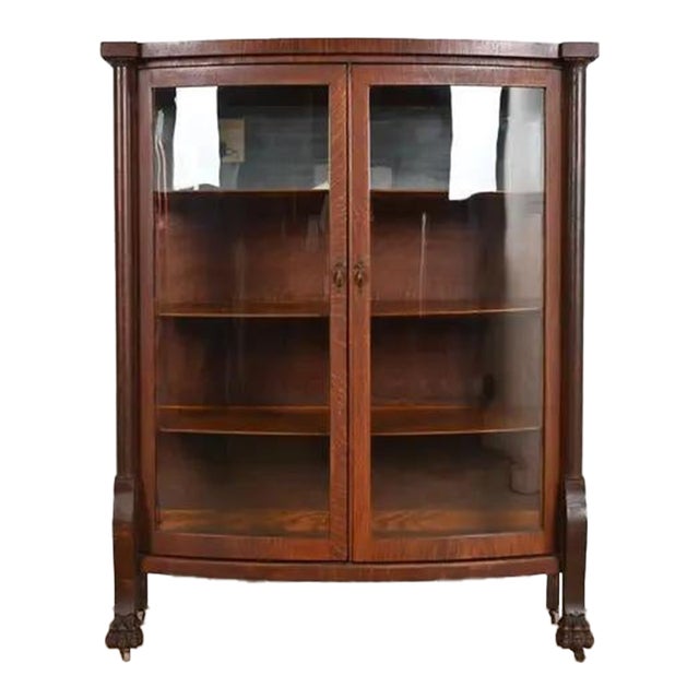 R. J. Horner Style Antique American Empire Oak Bow Front Bookcase Cabinet With Lion's Paw Feet, Circa 1890 For Sale