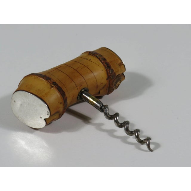 Bamboo corkscrew finished with silver plates on the sides.