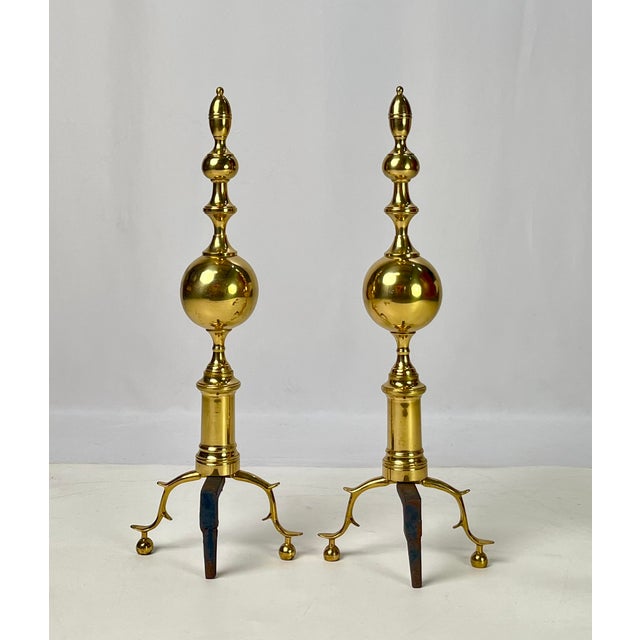Large pair of vintage solid brass and cast iron andirons. Standing nearly 30 inches tall, these fireplace dogs feature...