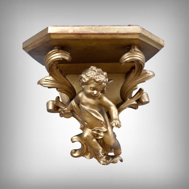This elegant pair of wall-mounted consoles in wood and gilt stucco displays its Baroque style with a generous proportions...