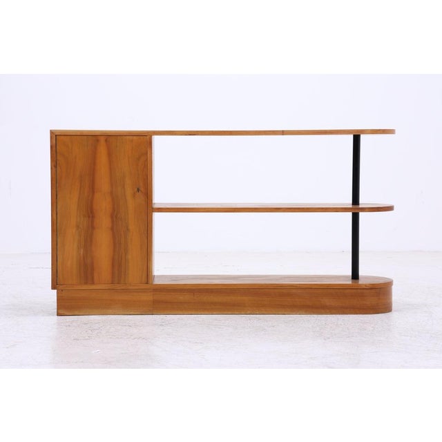 Vintage room divider with an open, asymmetrical layout and integrated cabinet compartment. The rounded shelf ends, black...