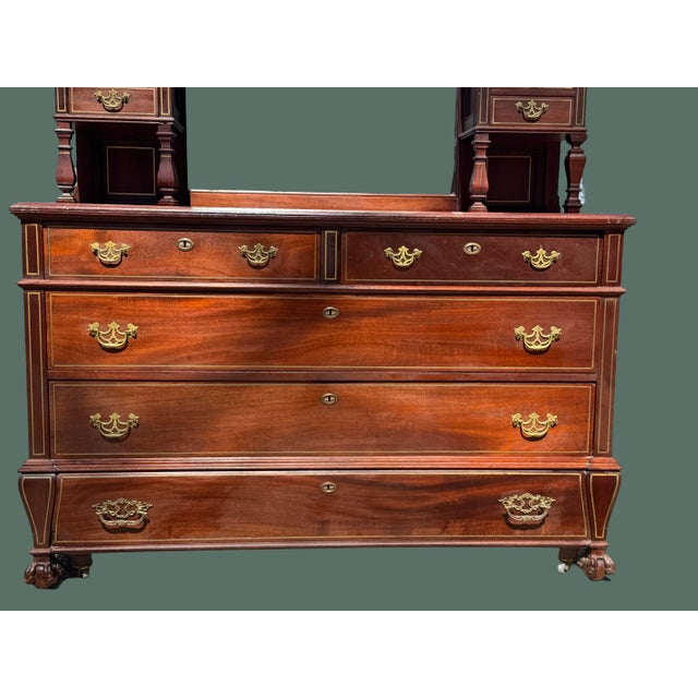 Beautiful solid wood piece strung with brass, the oblong mirrored superstructure flanked by banks of two short drawers on...